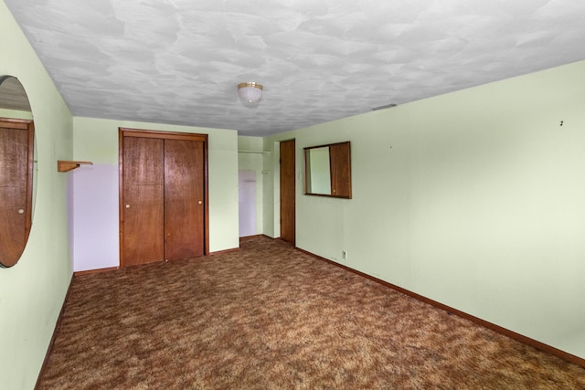 unfurnished bedroom featuring carpet floors, a closet, and baseboards