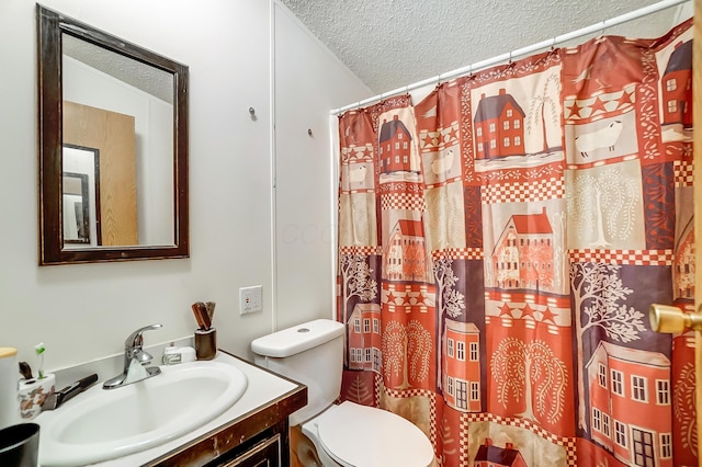 bathroom featuring toilet, curtained shower, a textured ceiling, and vanity