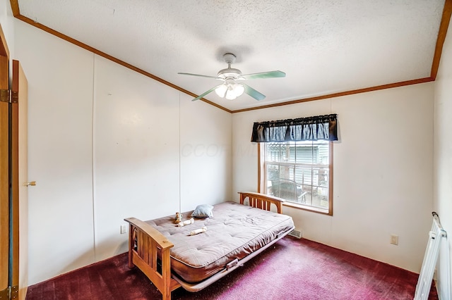 bedroom featuring a ceiling fan, dark colored carpet, crown molding, and a textured ceiling