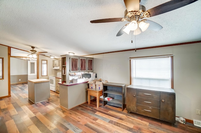 kitchen with a textured ceiling, white electric range, wood finished floors, visible vents, and open shelves