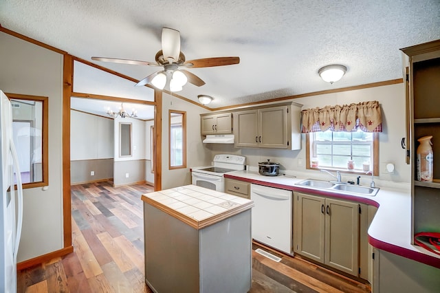 kitchen with lofted ceiling, light wood-style flooring, a kitchen island, a sink, and white appliances