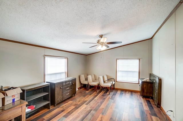 living area with lofted ceiling, ceiling fan, crown molding, and wood finished floors