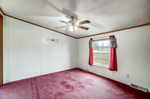 carpeted empty room with visible vents, crown molding, a textured ceiling, and ceiling fan