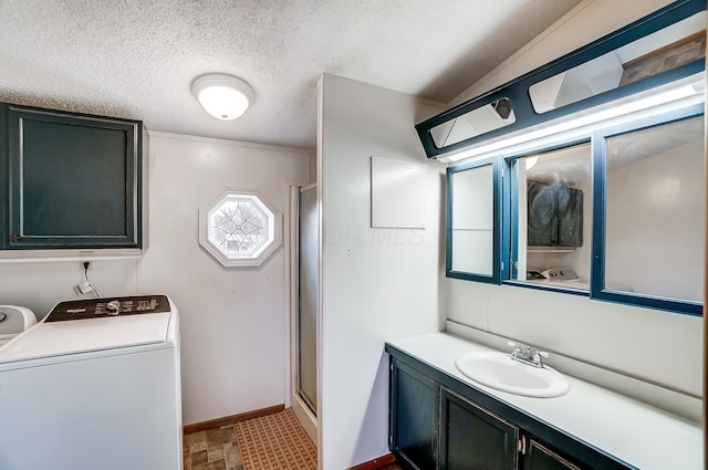 full bath with washer / dryer, a stall shower, baseboards, a textured ceiling, and vanity