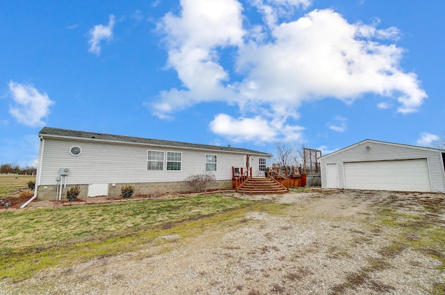 view of home's exterior featuring a garage, an outbuilding, a lawn, and a deck