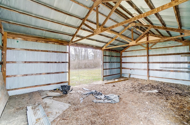 miscellaneous room with vaulted ceiling and metal wall