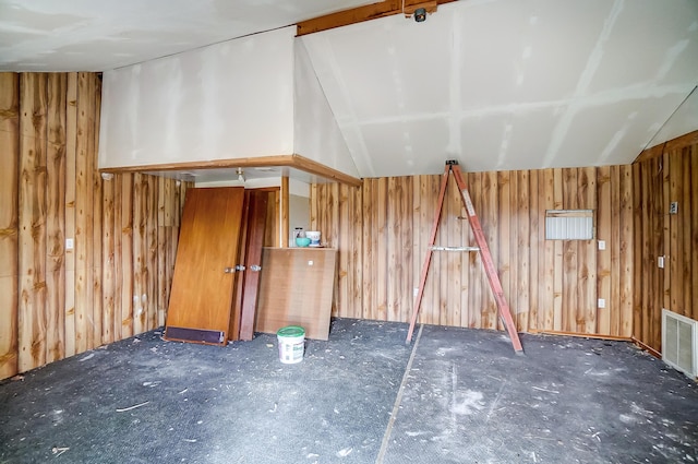 bonus room featuring visible vents and wooden walls