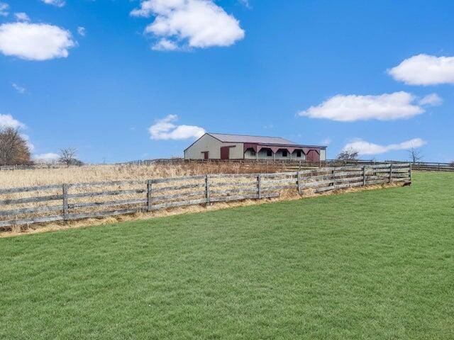 view of yard featuring a rural view and fence