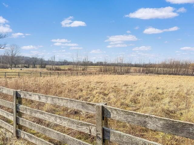 view of yard featuring a rural view and fence