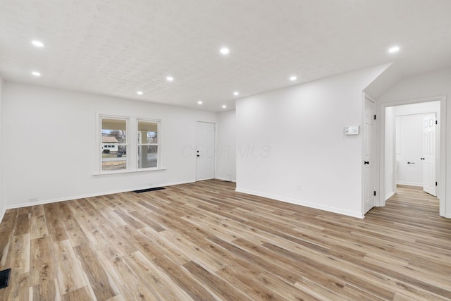 spare room featuring light wood-style flooring, baseboards, and recessed lighting