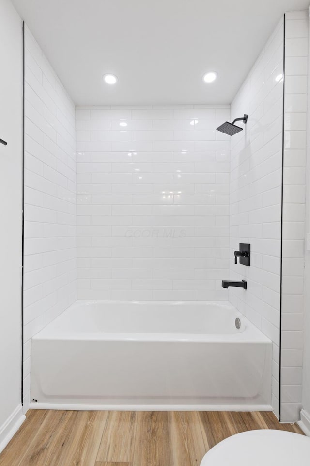 full bath with shower / bath combination, wood finished floors, toilet, and recessed lighting