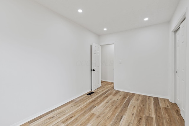 unfurnished bedroom featuring recessed lighting, visible vents, baseboards, a closet, and light wood-type flooring