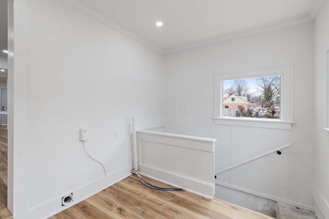 laundry area with light wood-style flooring, laundry area, baseboards, electric dryer hookup, and crown molding