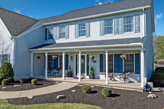 view of front of property with covered porch and roof with shingles
