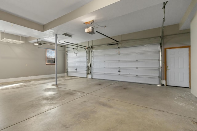 garage with a garage door opener and baseboards