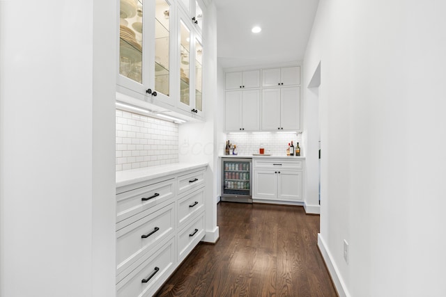 corridor with recessed lighting, baseboards, wine cooler, and dark wood-style flooring