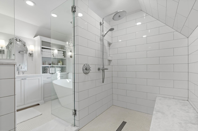 full bath with vanity, tile patterned flooring, a tile shower, and a freestanding bath