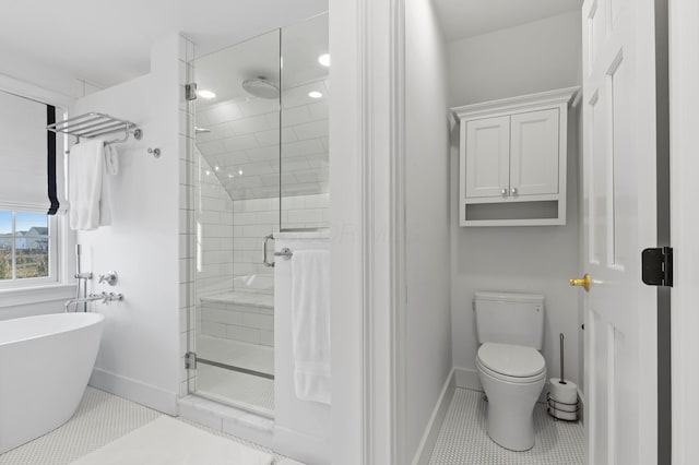 full bathroom with tile patterned flooring, baseboards, toilet, a stall shower, and a freestanding tub