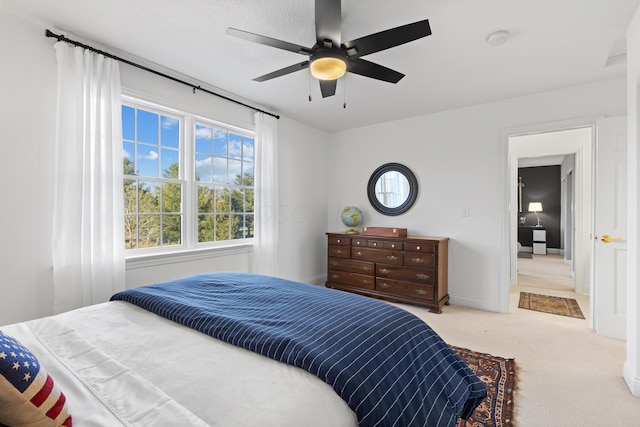 carpeted bedroom featuring baseboards and ceiling fan