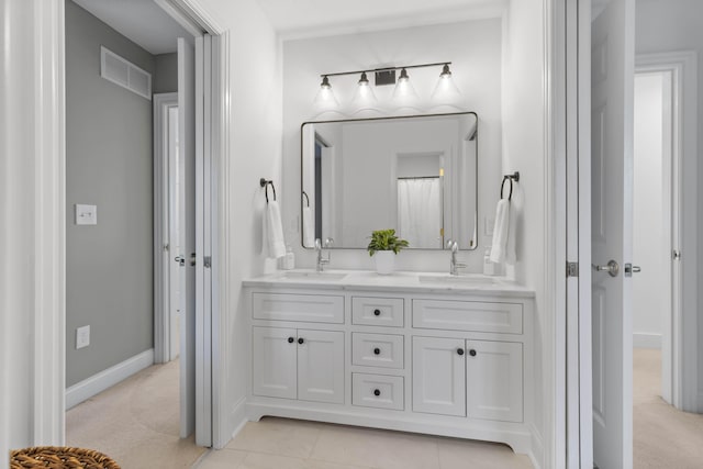 full bathroom with tile patterned flooring, double vanity, visible vents, and a sink