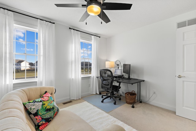 carpeted bedroom featuring baseboards, visible vents, and ceiling fan