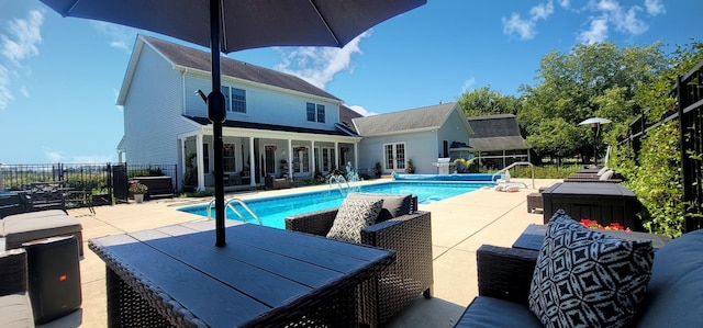 view of swimming pool featuring a patio area, a fenced in pool, and fence