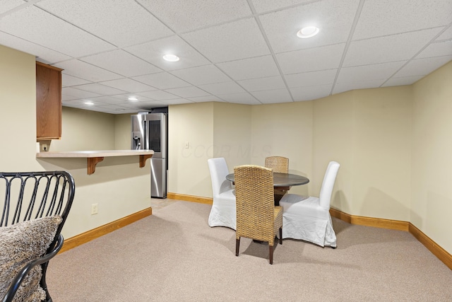 dining room with a paneled ceiling, recessed lighting, baseboards, and light carpet