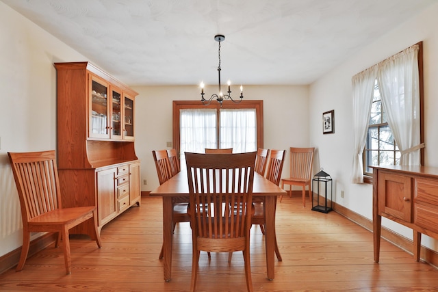 8871 Patterson Rd, Hilliard, OH 43026 - dining room featuring a chandelier, plenty of natural light, and light wood-type flooring