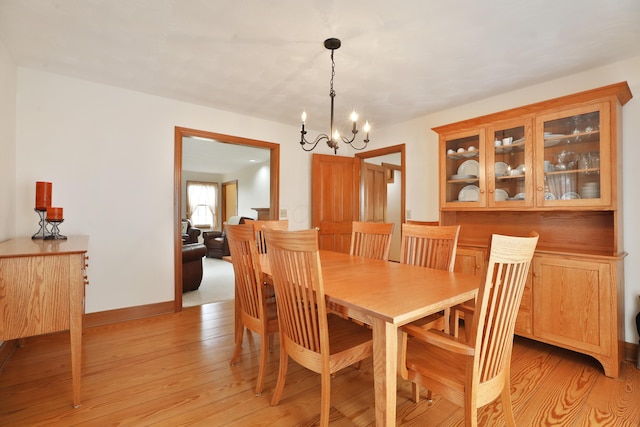 8871 Patterson Rd, Hilliard, OH 43026 - dining space featuring a chandelier and light wood-style floors