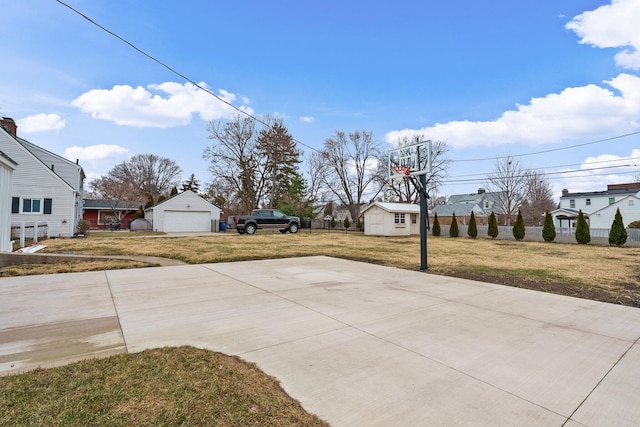 view of sport court featuring a residential view, a lawn, and fence