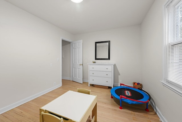 rec room with light wood finished floors and baseboards