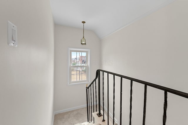 stairs with baseboards, vaulted ceiling, and carpet flooring