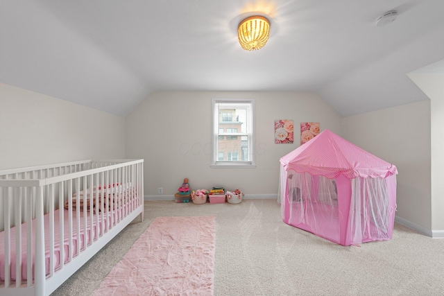 carpeted bedroom with lofted ceiling and baseboards