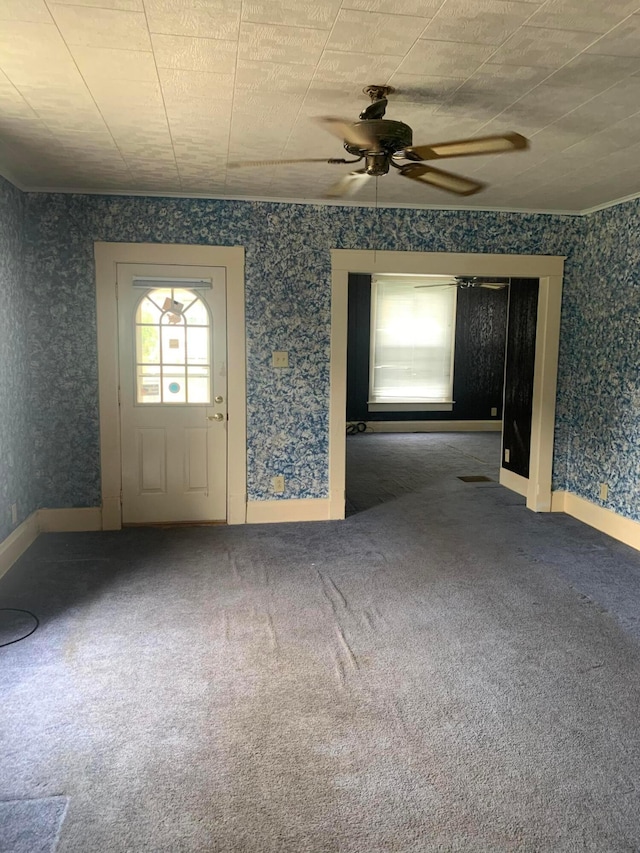 interior space featuring wallpapered walls, ceiling fan, and baseboards