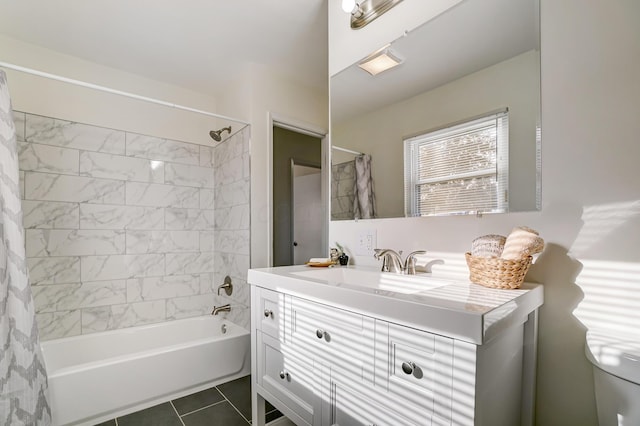 full bath with shower / tub combo, vanity, and tile patterned flooring