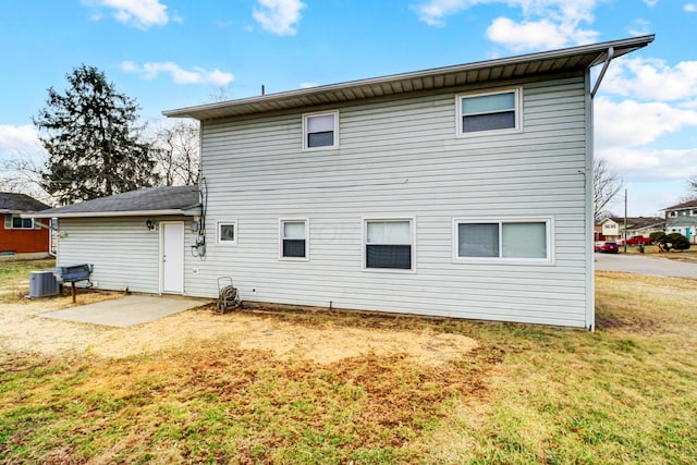 back of house with a yard and a patio