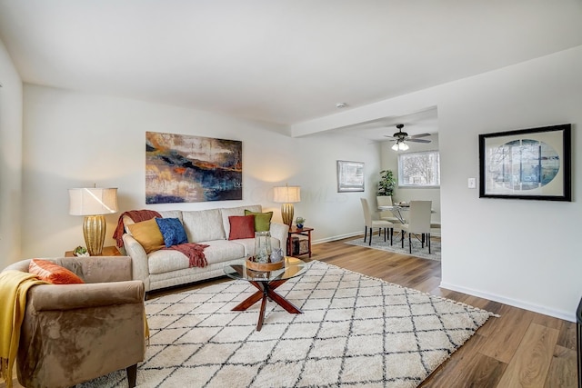 living area featuring baseboards and wood finished floors