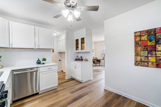 kitchen with light wood-type flooring, white cabinetry, dishwasher, and light countertops