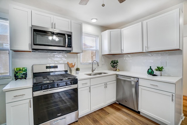 kitchen featuring light countertops, a ceiling fan, appliances with stainless steel finishes, and a sink