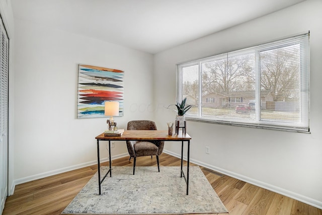 office space with baseboards and wood finished floors