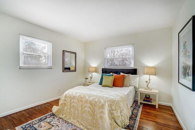 bedroom with wood finished floors and baseboards