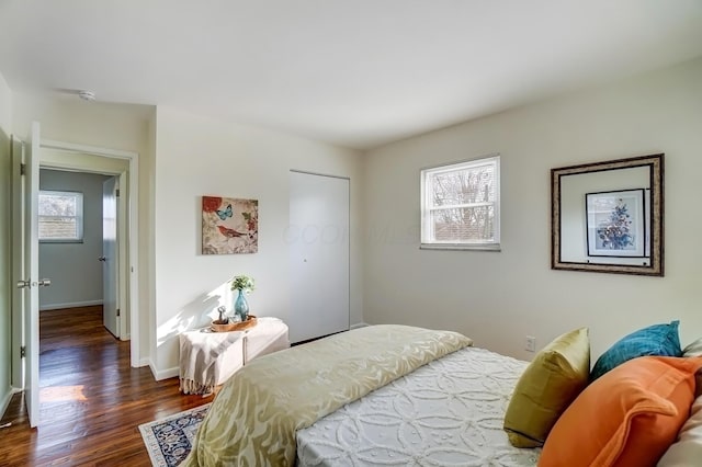 bedroom featuring wood finished floors and baseboards