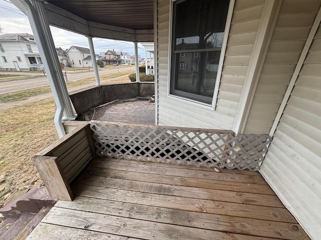 wooden terrace featuring a residential view