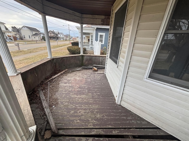 wooden deck featuring a porch and a residential view