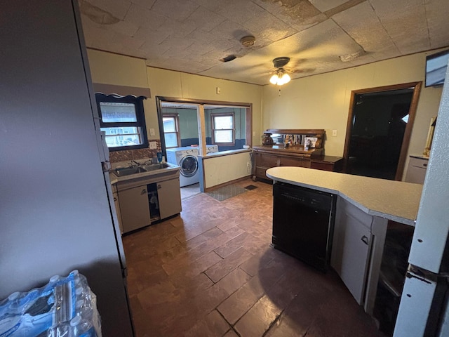 kitchen with dishwasher, ceiling fan, washer / clothes dryer, and a sink