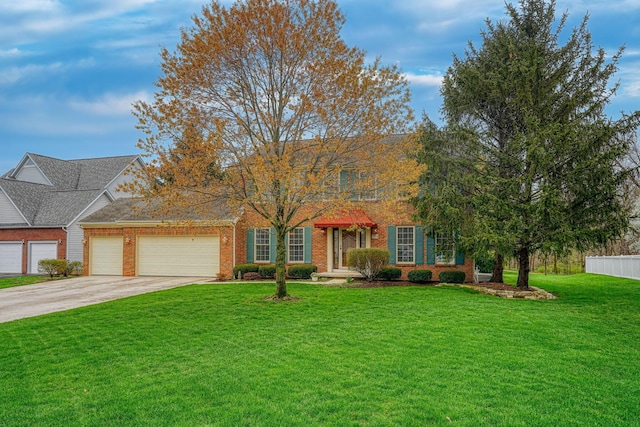 7334 Crossett Ct, Canal Winchester, OH 43110 - view of front facade with concrete driveway, a front lawn, brick siding, a garage, and fence