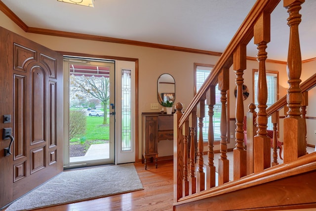 7334 Crossett Ct, Canal Winchester, OH 43110 - entryway with ornamental molding, baseboards, stairway, and light wood-style floors