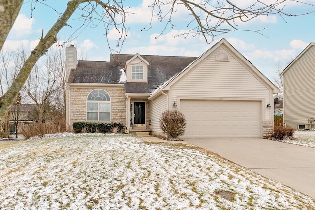 view of front of property with an attached garage, stone siding, a chimney, and concrete driveway