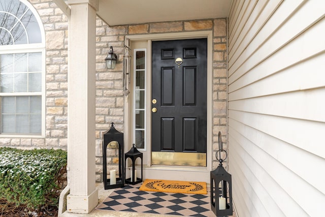 doorway to property with stone siding