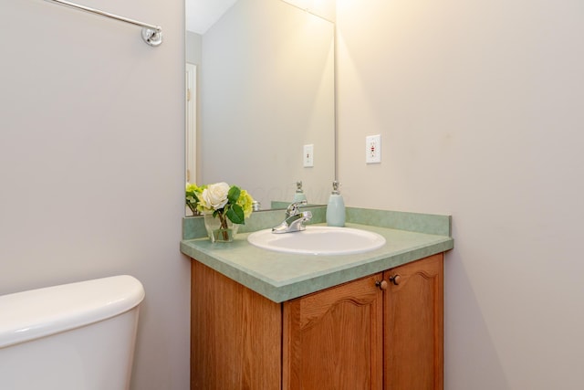 bathroom featuring toilet and vanity